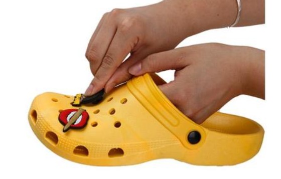 Put Jibbitz through hole on Crocs